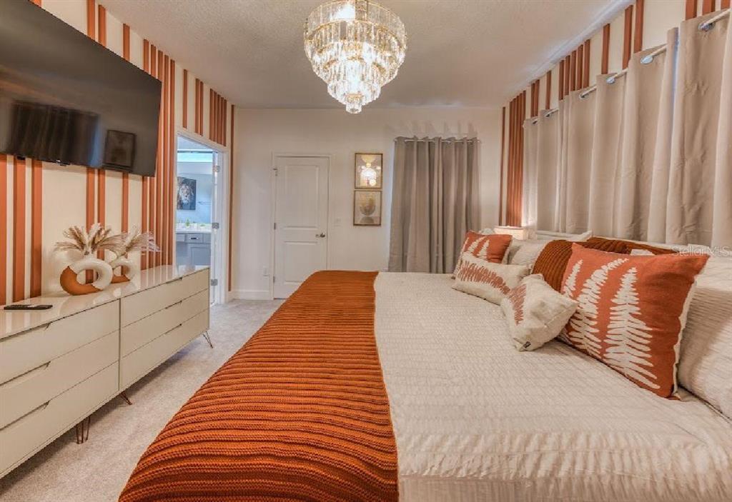 6301 Sand Skipper Road Orlando, FL 32821 - Photo 34 of 80 a bed sitting in a bedroom next to a window