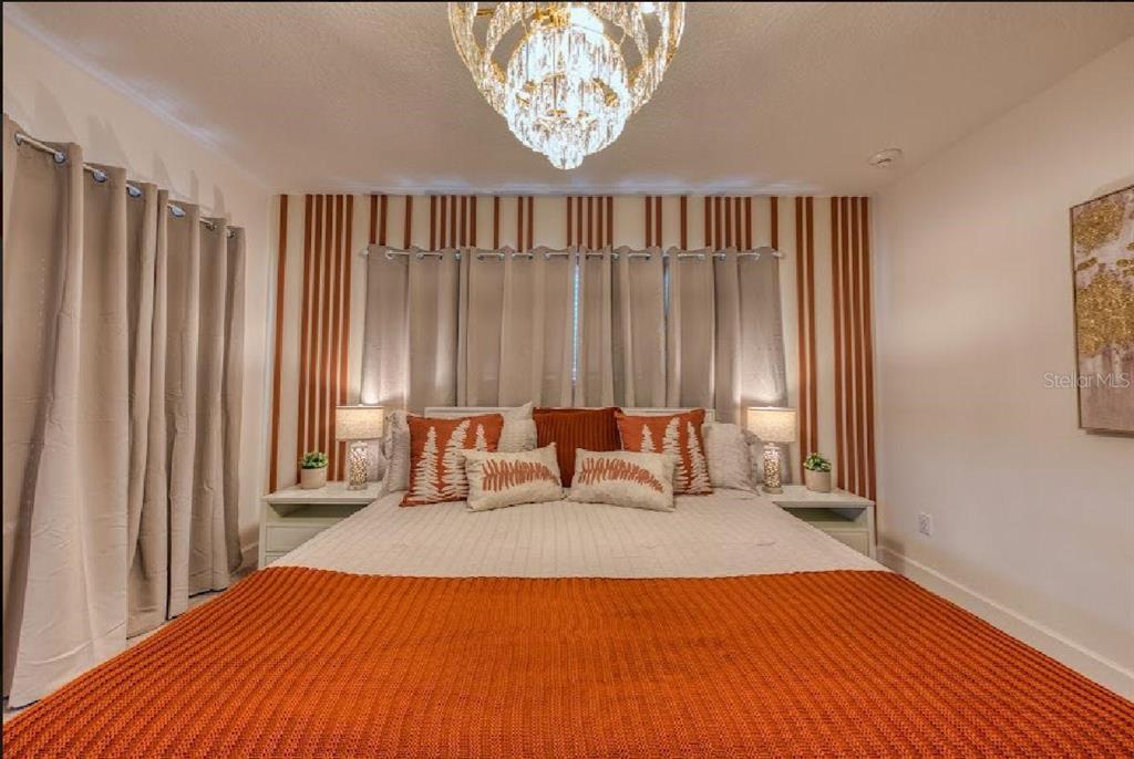 6301 Sand Skipper Road Orlando, FL 32821 - Photo 37 of 80 a bed sitting in a bedroom next to a window