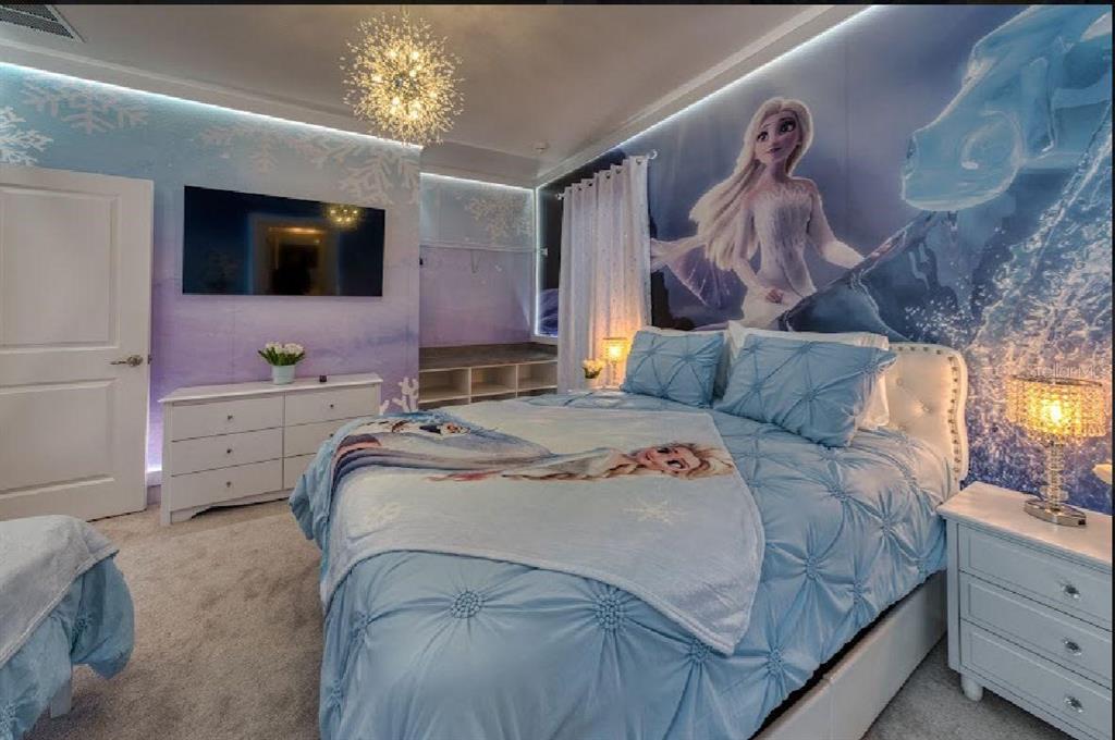 6301 Sand Skipper Road Orlando, FL 32821 - Photo 40 of 80 a bedroom with a bed and a flat tv screen on dresser