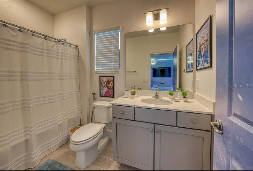 6301 Sand Skipper Road Orlando, FL 32821 - Photo 41 of 80 a bathroom with a sink a toilet and shower