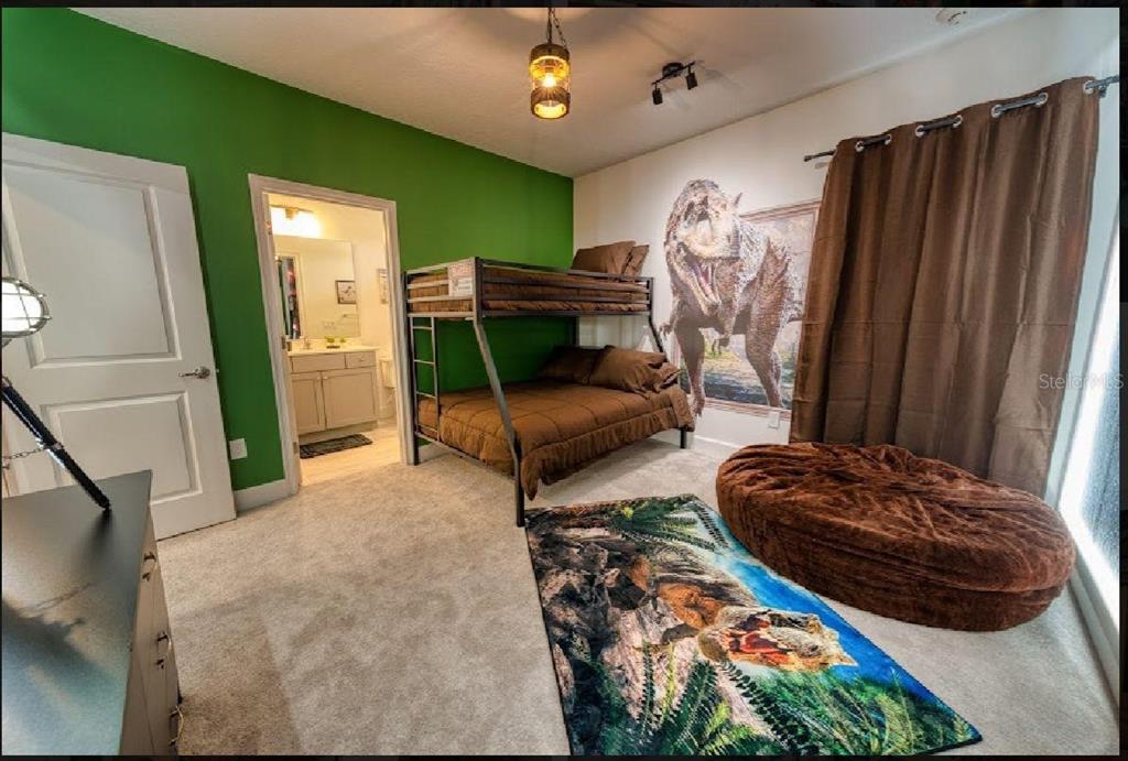 6301 Sand Skipper Road Orlando, FL 32821 - Photo 42 of 80 a bedroom with bed and a mirror