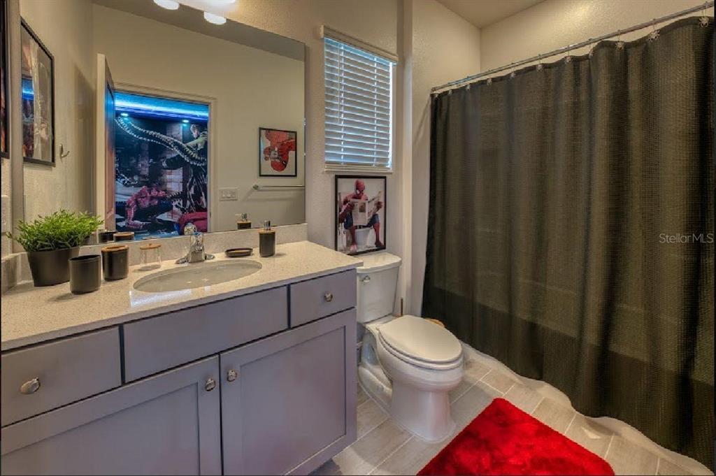 6301 Sand Skipper Road Orlando, FL 32821 - Photo 48 of 80 a bathroom with a sink and a mirror