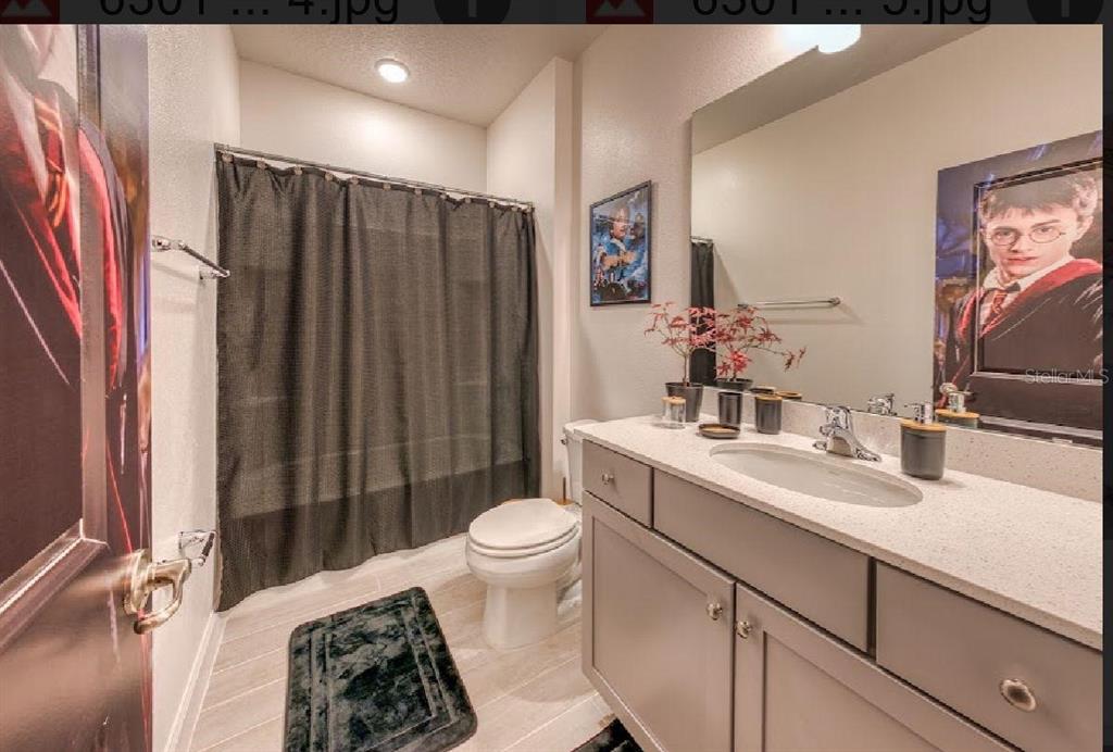 6301 Sand Skipper Road Orlando, FL 32821 - Photo 57 of 80 a bathroom with a sink toilet and shower