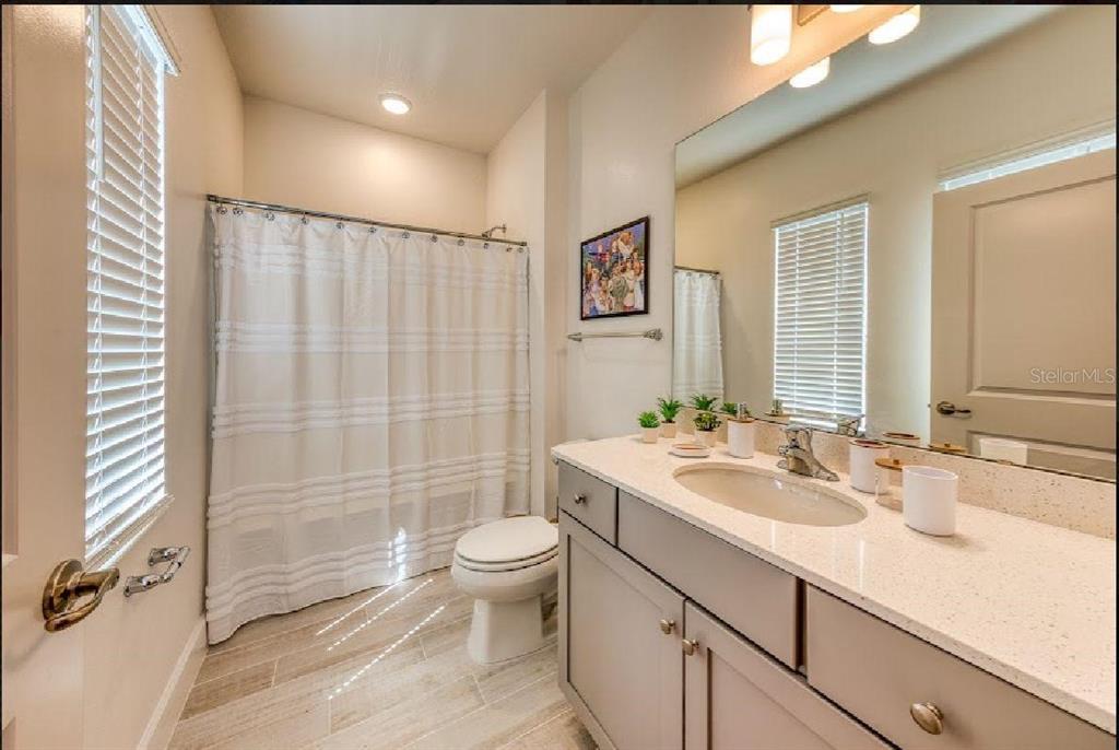 6301 Sand Skipper Road Orlando, FL 32821 - Photo 60 of 80 a bathroom with a sink a toilet and shower
