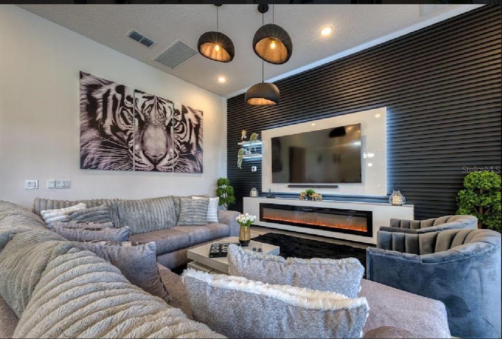 6301 Sand Skipper Road Orlando, FL 32821 - Photo 6 of 80 a living room with furniture and a flat screen tv