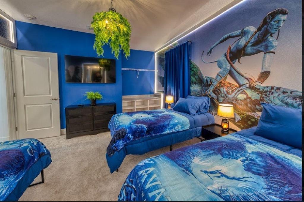 6301 Sand Skipper Road Orlando, FL 32821 - Photo 62 of 80 a bedroom with two beds and a potted plant