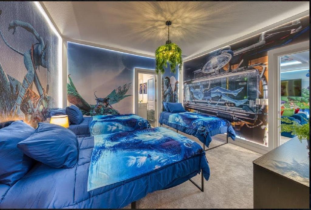 6301 Sand Skipper Road Orlando, FL 32821 - Photo 64 of 80 a living room with couches chandelier and a fireplace with wooden floor