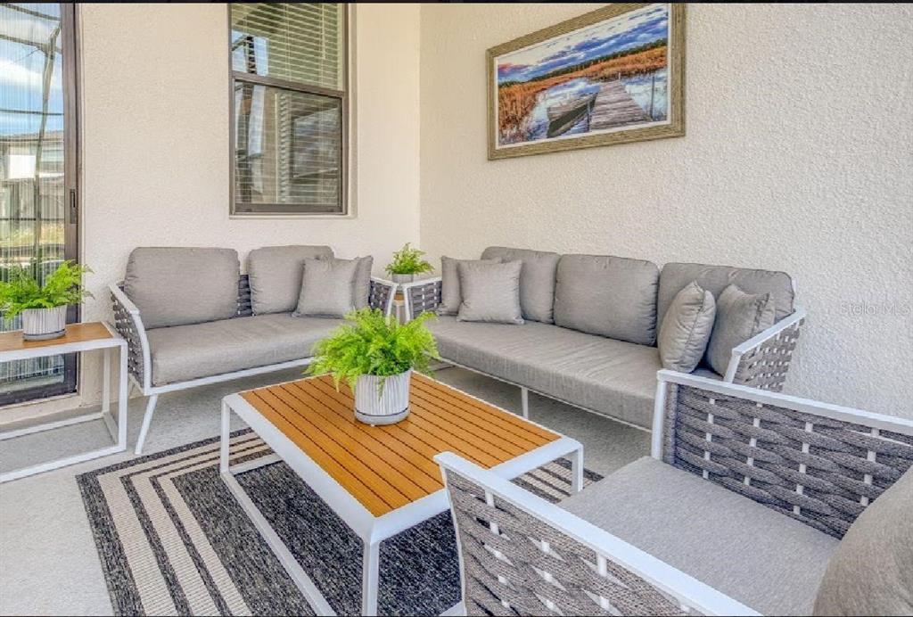 6301 Sand Skipper Road Orlando, FL 32821 - Photo 68 of 80 a living room with furniture and a rug