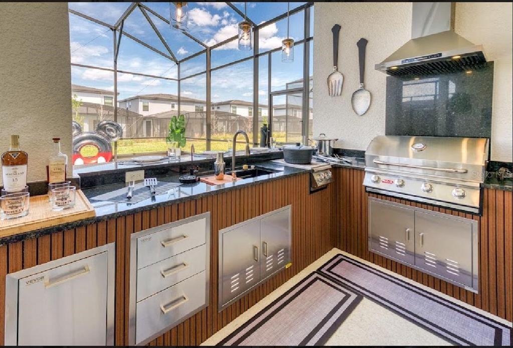 6301 Sand Skipper Road Orlando, FL 32821 - Photo 69 of 80 a kitchen with stainless steel appliances granite countertop a stove a sink and a microwave