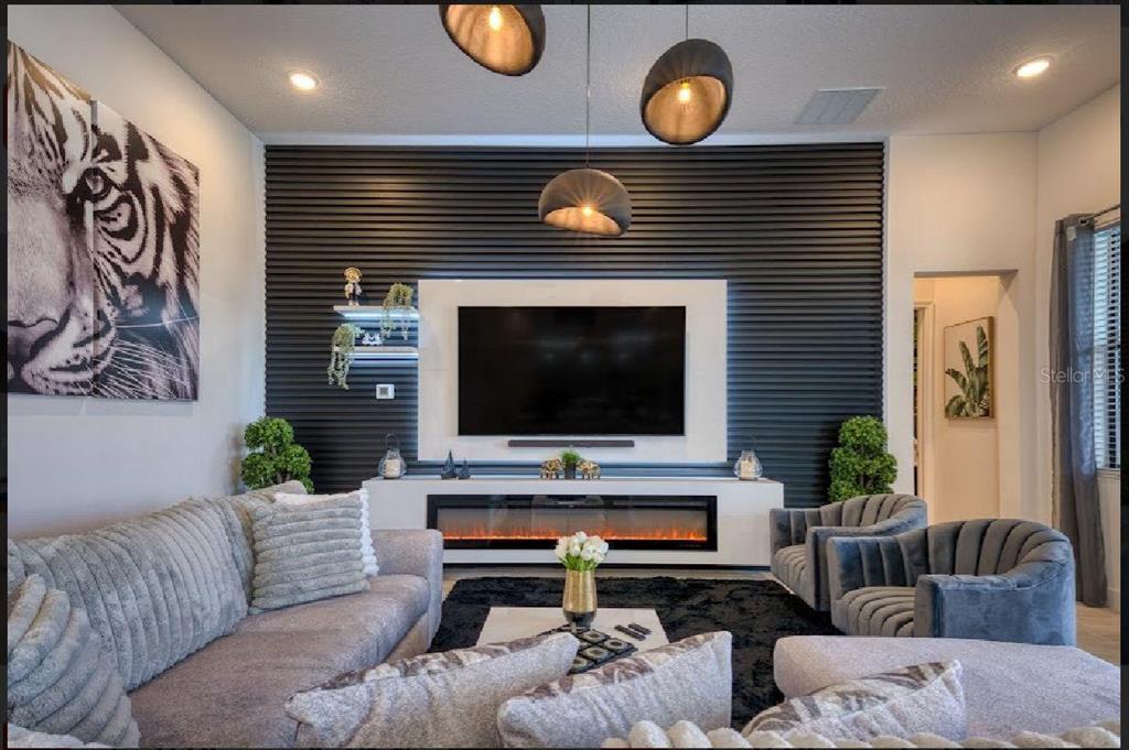 6301 Sand Skipper Road Orlando, FL 32821 - Photo 7 of 80 a living room with furniture and a flat screen tv