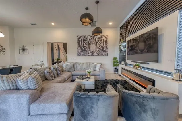 a view of a dining room with furniture a chandelier and wooden floor
