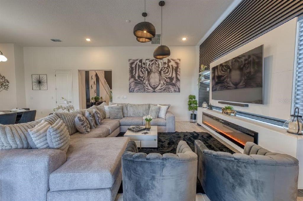 6301 Sand Skipper Road Orlando, FL 32821 - Photo 8 of 80 a living room with furniture and a flat screen tv