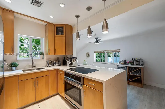 a kitchen that has a sink a stove and a wooden floor