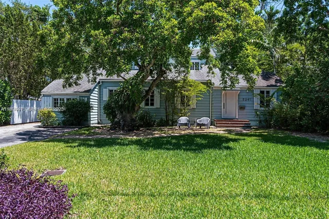 a front view of a house with swimming pool having outdoor seating