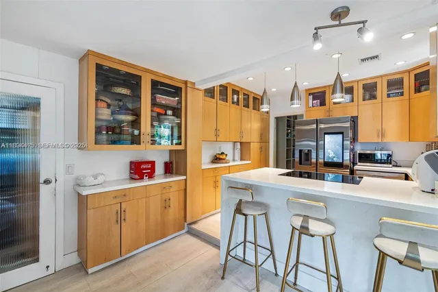 a kitchen with stainless steel appliances granite countertop a sink and cabinets
