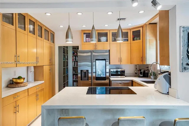 a kitchen with a sink and a refrigerator