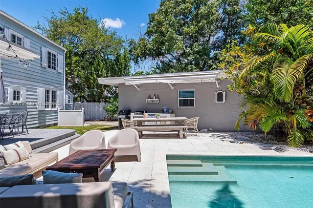 a view of backyard of house with seating area