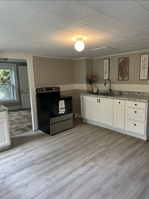 27-29 Allen Street Gardner, MA 01440 - Photo 12 of 30 a kitchen with granite countertop a stove a fireplace and a wooden floors