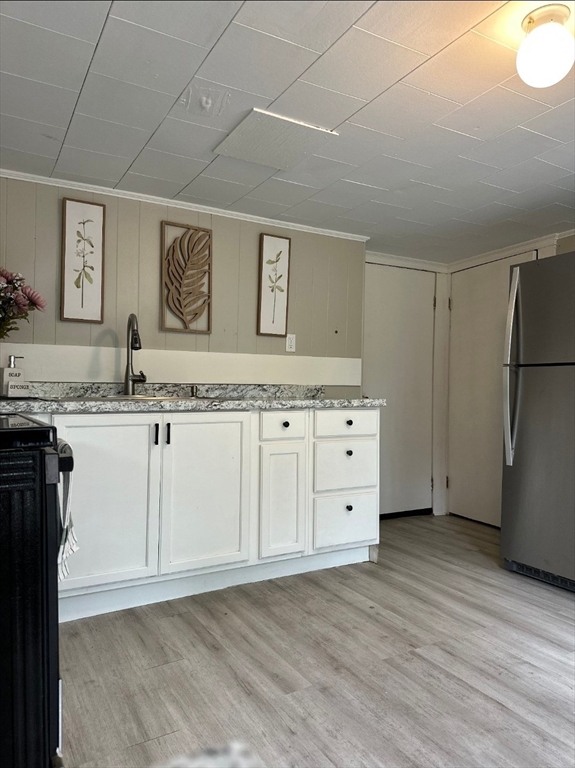 27-29 Allen Street Gardner, MA 01440 - Photo 13 of 30 a kitchen with granite countertop white cabinets and refrigerator