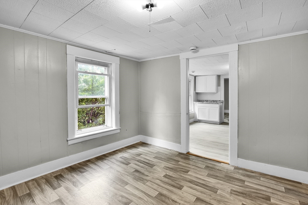 27-29 Allen Street Gardner, MA 01440 - Photo 16 of 30 an empty room with wooden floor and windows