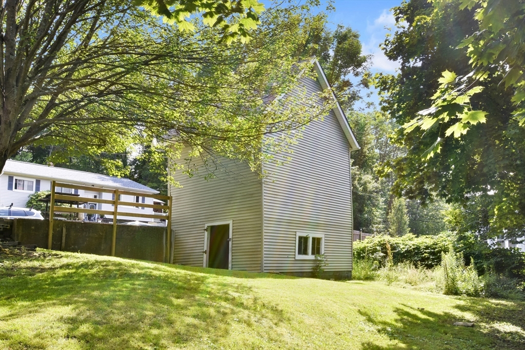 27-29 Allen Street Gardner, MA 01440 - Photo 29 of 30 a backyard of a house with yard and outdoor seating
