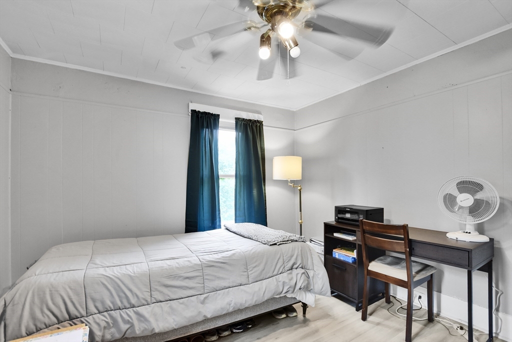 27-29 Allen Street Gardner, MA 01440 - Photo 8 of 30 a bedroom with a bed and a chandelier