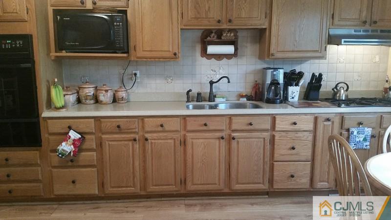 10 Hansen Road Old Bridge, NJ 08857 - Photo 5 of 24 a kitchen with stainless steel appliances granite countertop a sink a stove and cabinets