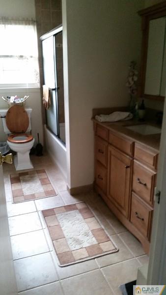 10 Hansen Road Old Bridge, NJ 08857 - Photo 8 of 24 a bathroom with a granite countertop sink and a toilet