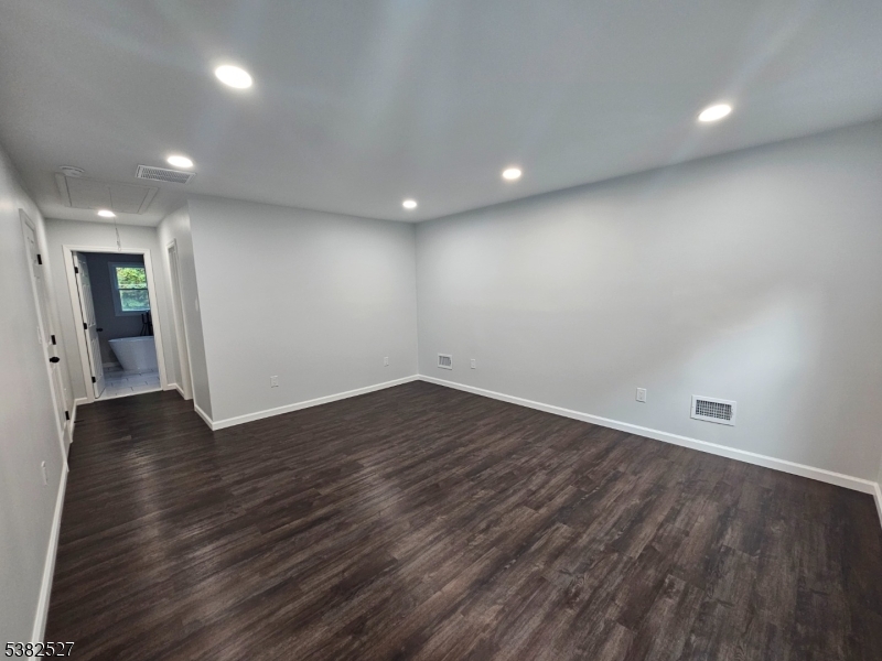 43 Rockport Road Wantage, NJ 07461 - Photo 11 of 30 an empty room with wooden floor and windows