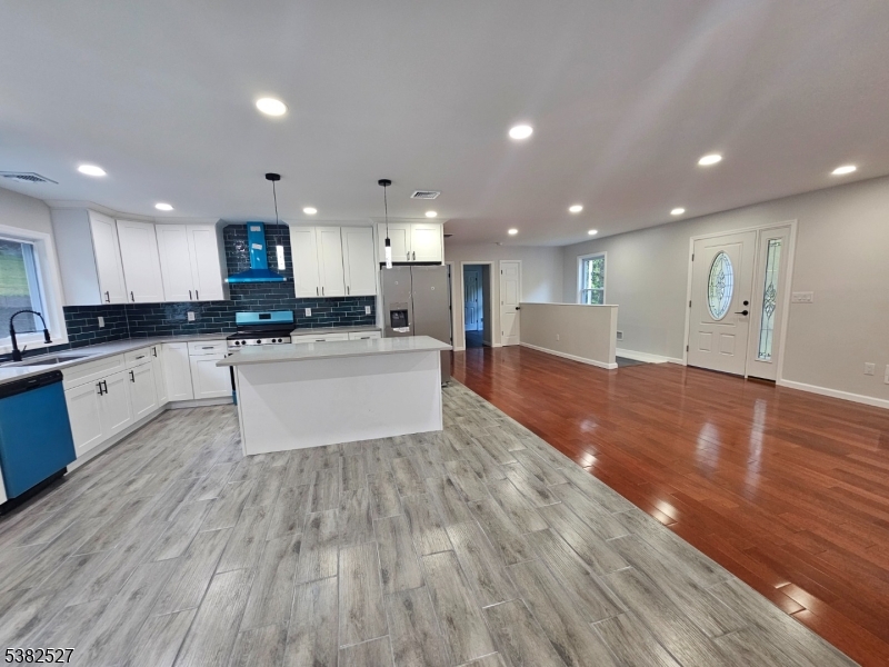 43 Rockport Road Wantage, NJ 07461 - Photo 13 of 30 a large kitchen with kitchen island a sink wooden floor and stainless steel appliances