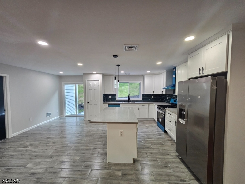 43 Rockport Road Wantage, NJ 07461 - Photo 16 of 30 a kitchen with stainless steel appliances kitchen island refrigerator stove and oven