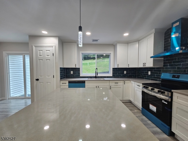 43 Rockport Road Wantage, NJ 07461 - Photo 19 of 30 a kitchen with stainless steel appliances a stove a sink a stove a refrigerator a center island and cabinets