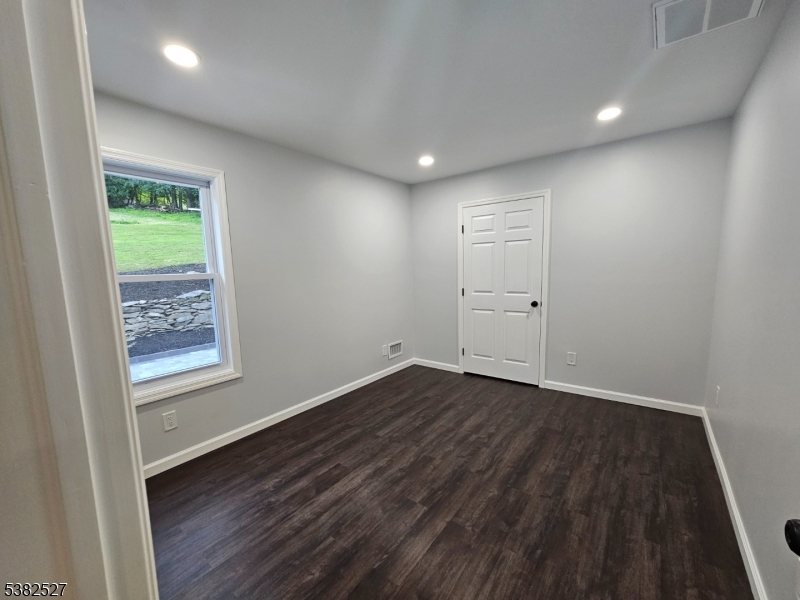 43 Rockport Road Wantage, NJ 07461 - Photo 22 of 30 an empty room with wooden floor and windows