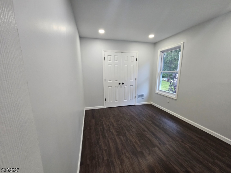 43 Rockport Road Wantage, NJ 07461 - Photo 23 of 30 an empty room with wooden floor and windows