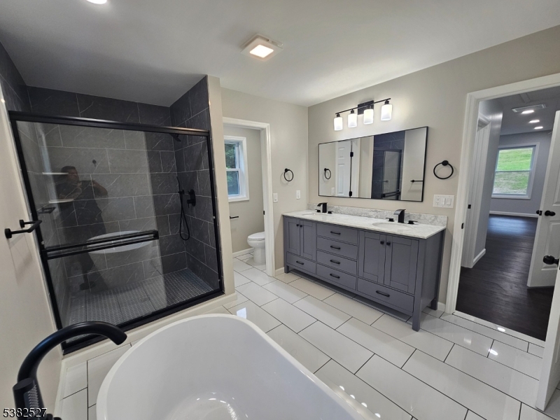 43 Rockport Road Wantage, NJ 07461 - Photo 5 of 30 a bathroom with a tub sink and mirror