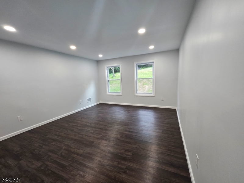 43 Rockport Road Wantage, NJ 07461 - Photo 7 of 30 an empty room with wooden floor and windows