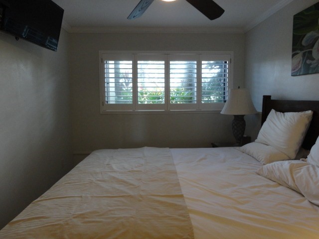 5050 Lawai Road, Unit 101 Koloa, HI 96756 - Photo 14 of 24 a bedroom with a bed and a window