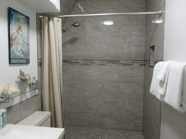 5050 Lawai Road, Unit 101 Koloa, HI 96756 - Photo 16 of 24 a bathroom with a shower and toilet