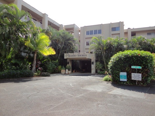 5050 Lawai Road, Unit 101 Koloa, HI 96756 - Photo 23 of 24 a front view of a building with a garden and plants