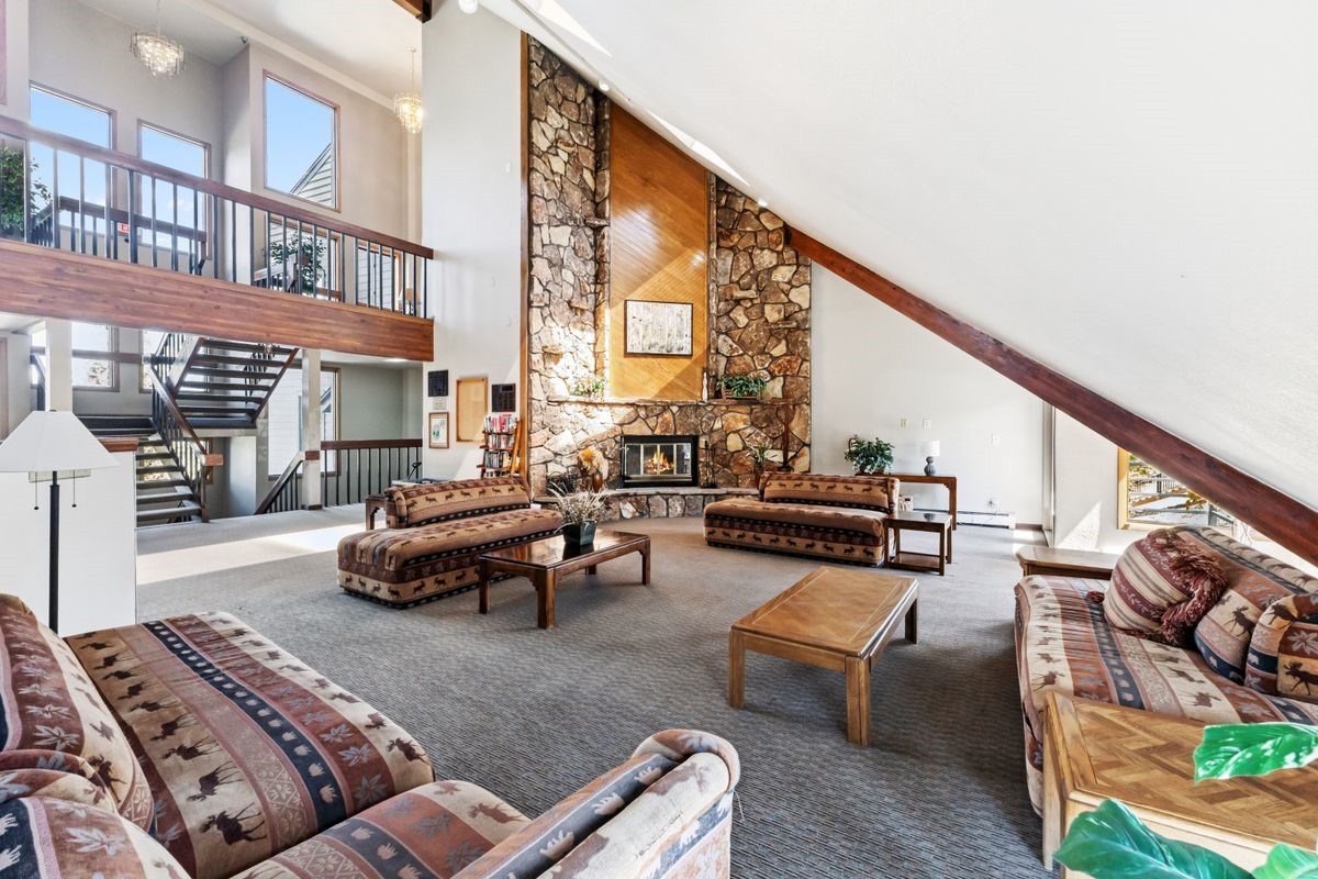 89410 Ryan Gulch Road, Unit 208 Silverthorne, CO 80498 - Photo 20 of 30 a living room with furniture and a floor to ceiling window or couch