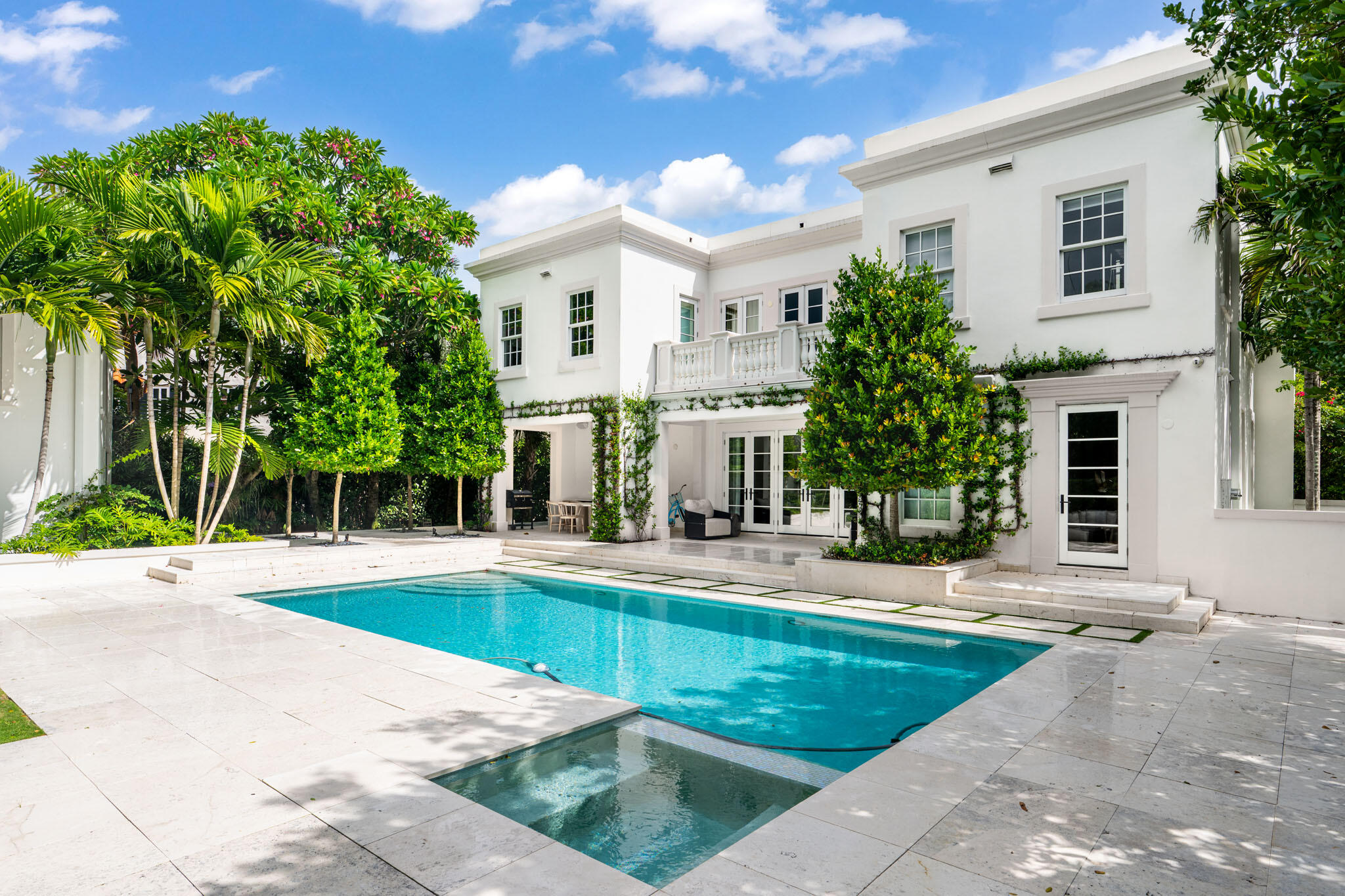 142 South County Road Palm Beach, FL 33480 - Photo 23 of 31 a view of a white house with a yard and plants