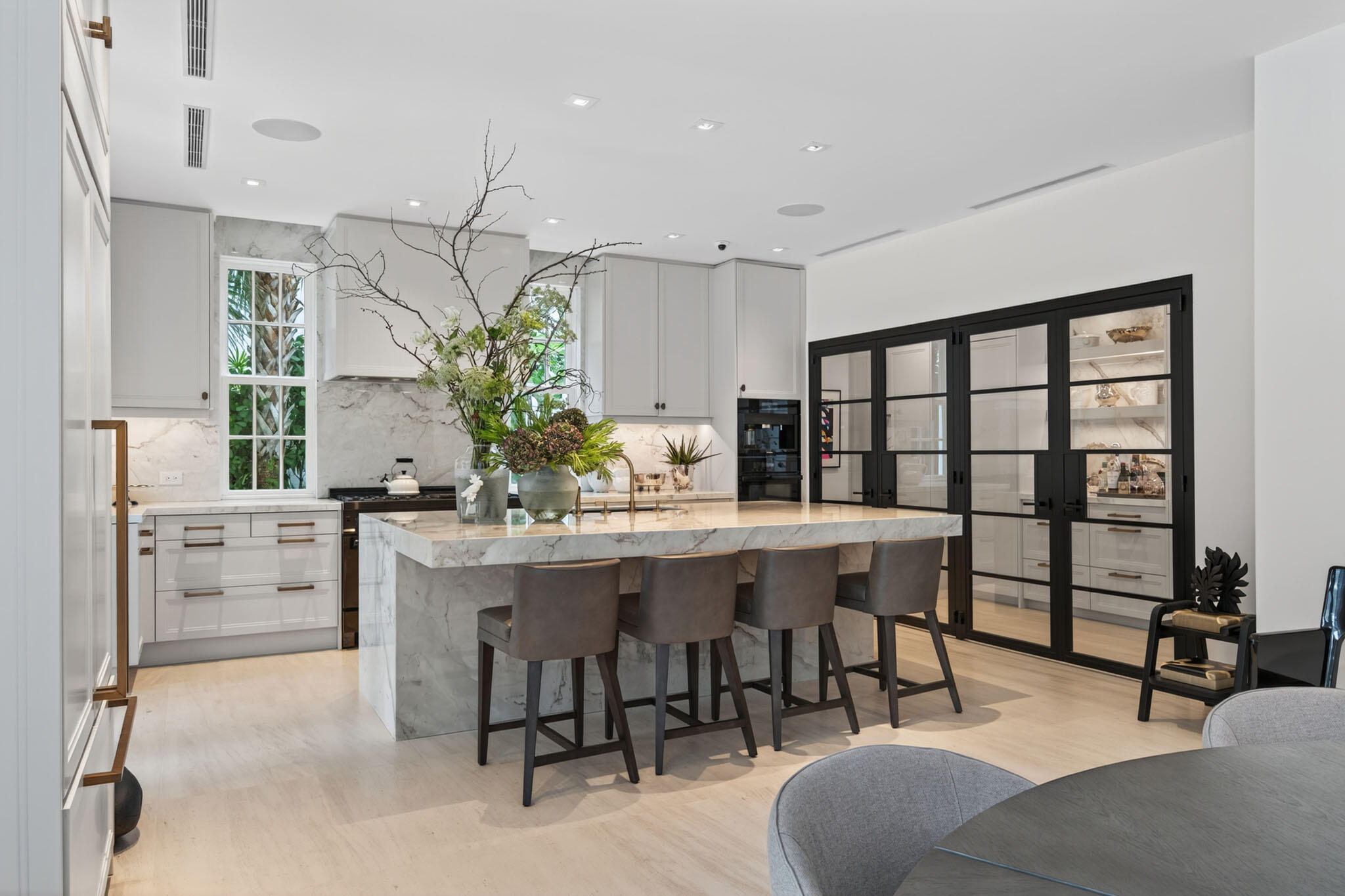 142 South County Road Palm Beach, FL 33480 - Photo 6 of 31 a dining hall with stainless steel appliances kitchen island granite countertop furniture and a potted plant