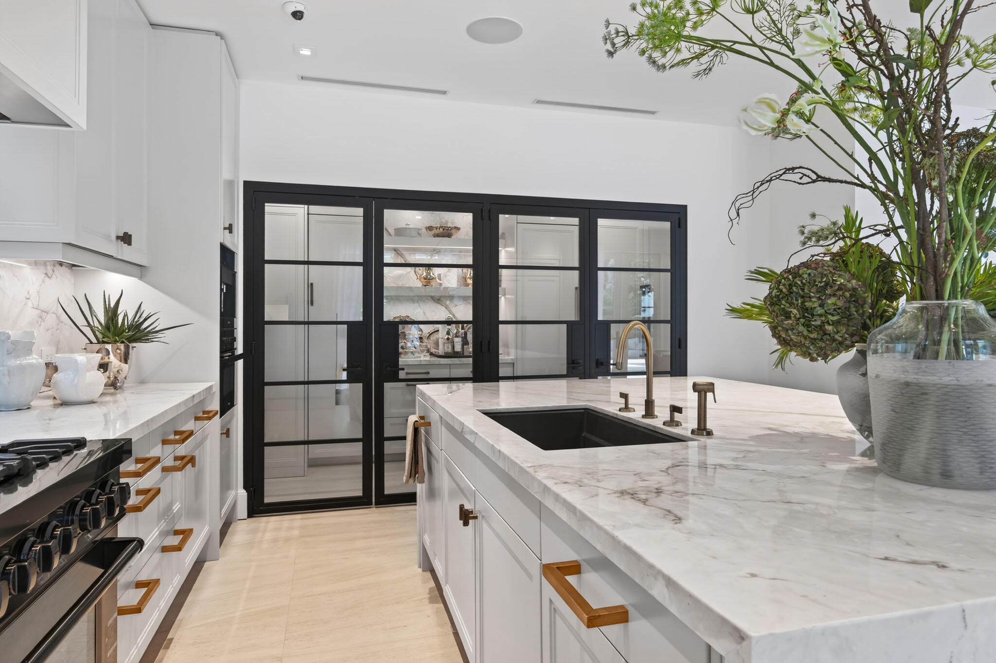 142 South County Road Palm Beach, FL 33480 - Photo 8 of 31 a kitchen with stainless steel appliances granite countertop a sink and a wooden floors