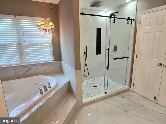 a living room with furniture a flat screen tv and a table