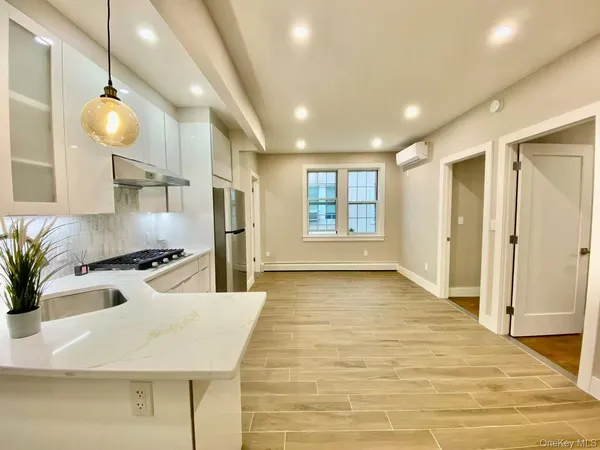a kitchen with stainless steel appliances granite countertop a sink and a refrigerator
