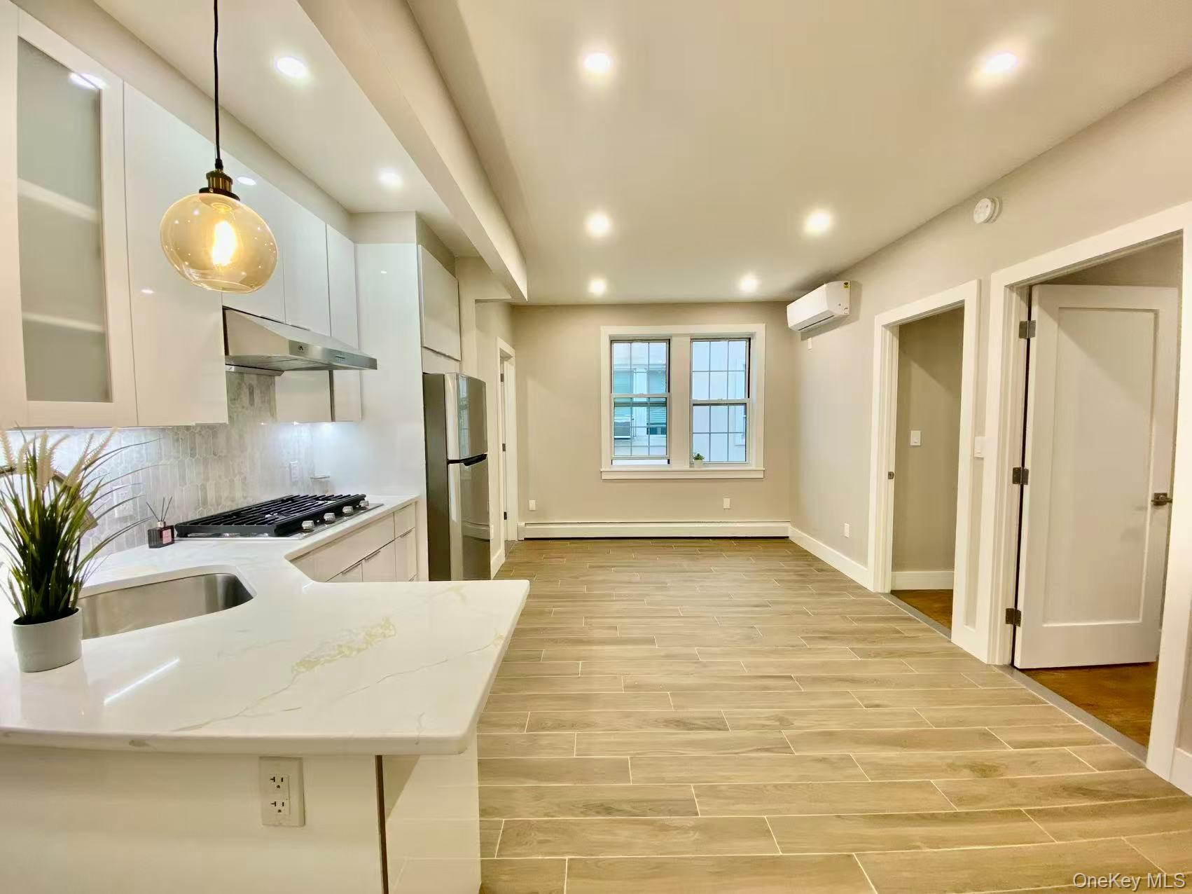 89-21 69th Road Queens, NY 11375 - Photo 1 of 1 a kitchen with stainless steel appliances granite countertop a sink and a refrigerator