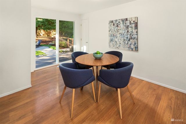 a dining room with furniture and wooden floor