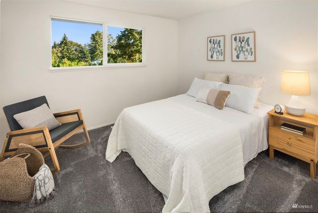 a bedroom with a bed and a chair