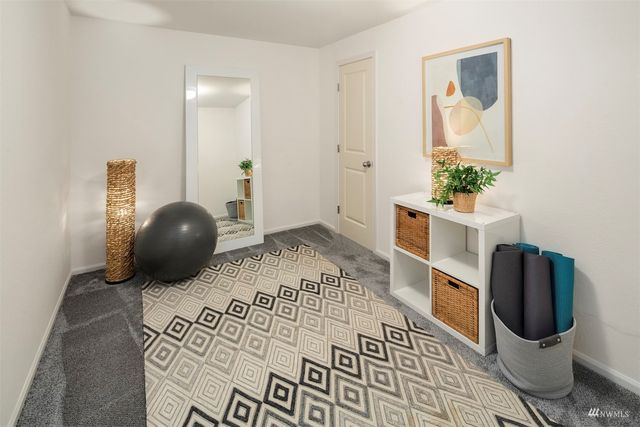 a living room with furniture and a mirror