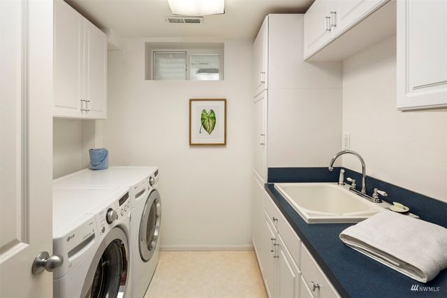 a bathroom with a sink a washer and dryer